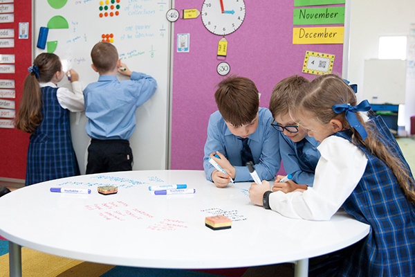 St Francis de Sales Catholic Primary School Woolooware Modern Classroom Students working around and writing on whiteboard table