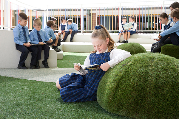 St Francis de Sales Catholic Primary School Woolooware Outdoor Classroom Students enjoying reading in green outdoor classroom