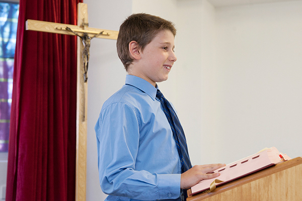 St Francis de Sales Catholic Primary School Shared Mision Student at lectern